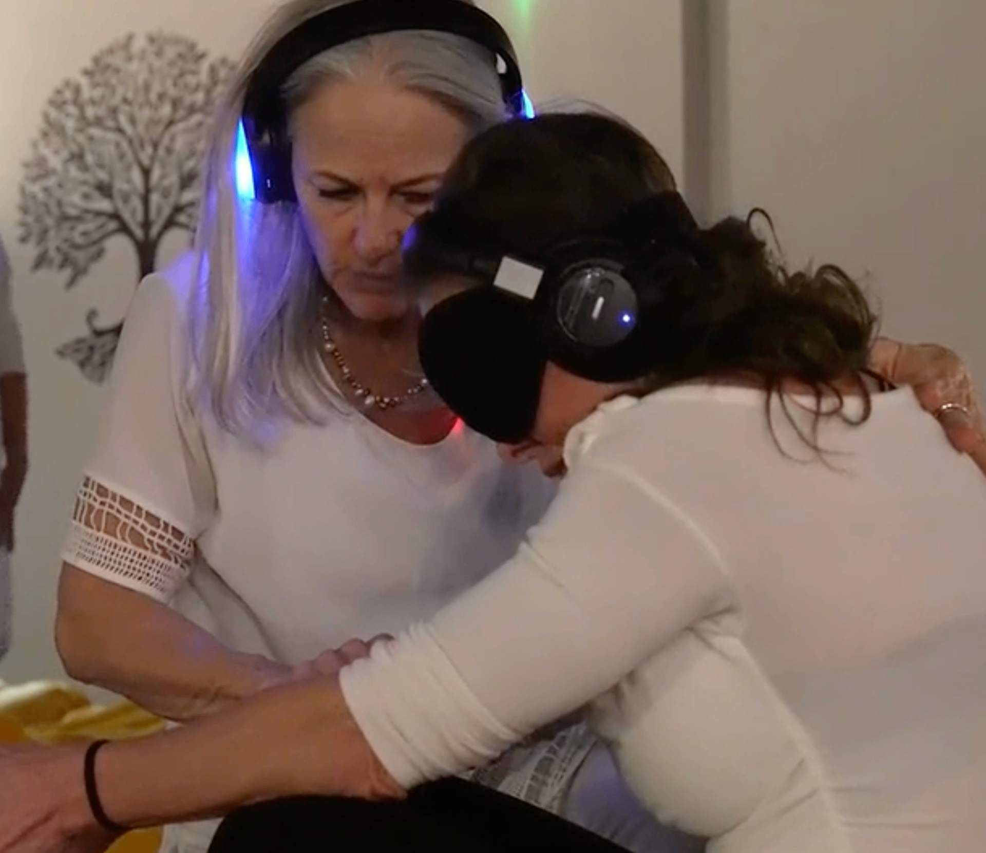 Colette embracing a guest during an emotional release