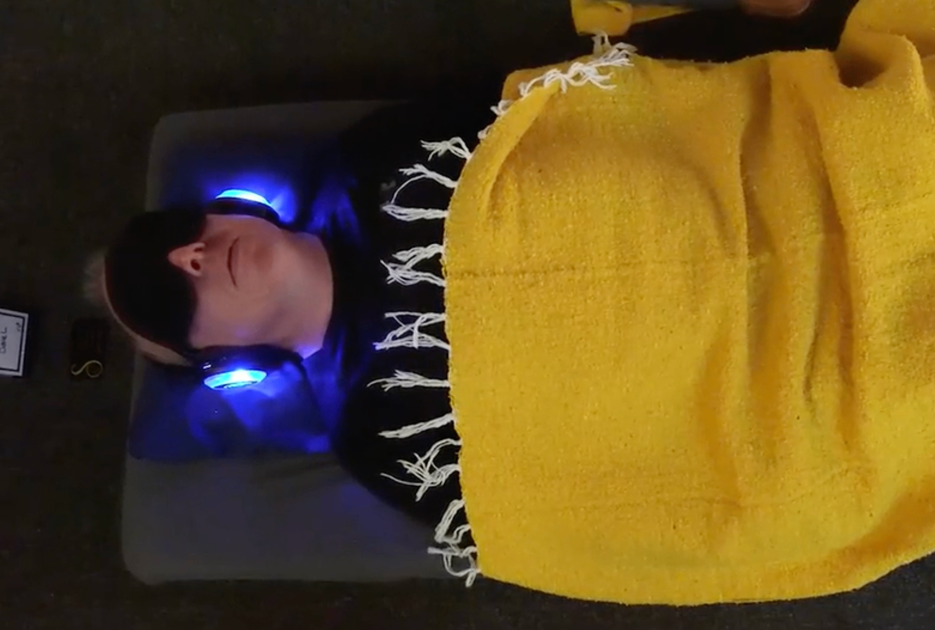 Guest deeply relaxed with glowing blue headphones