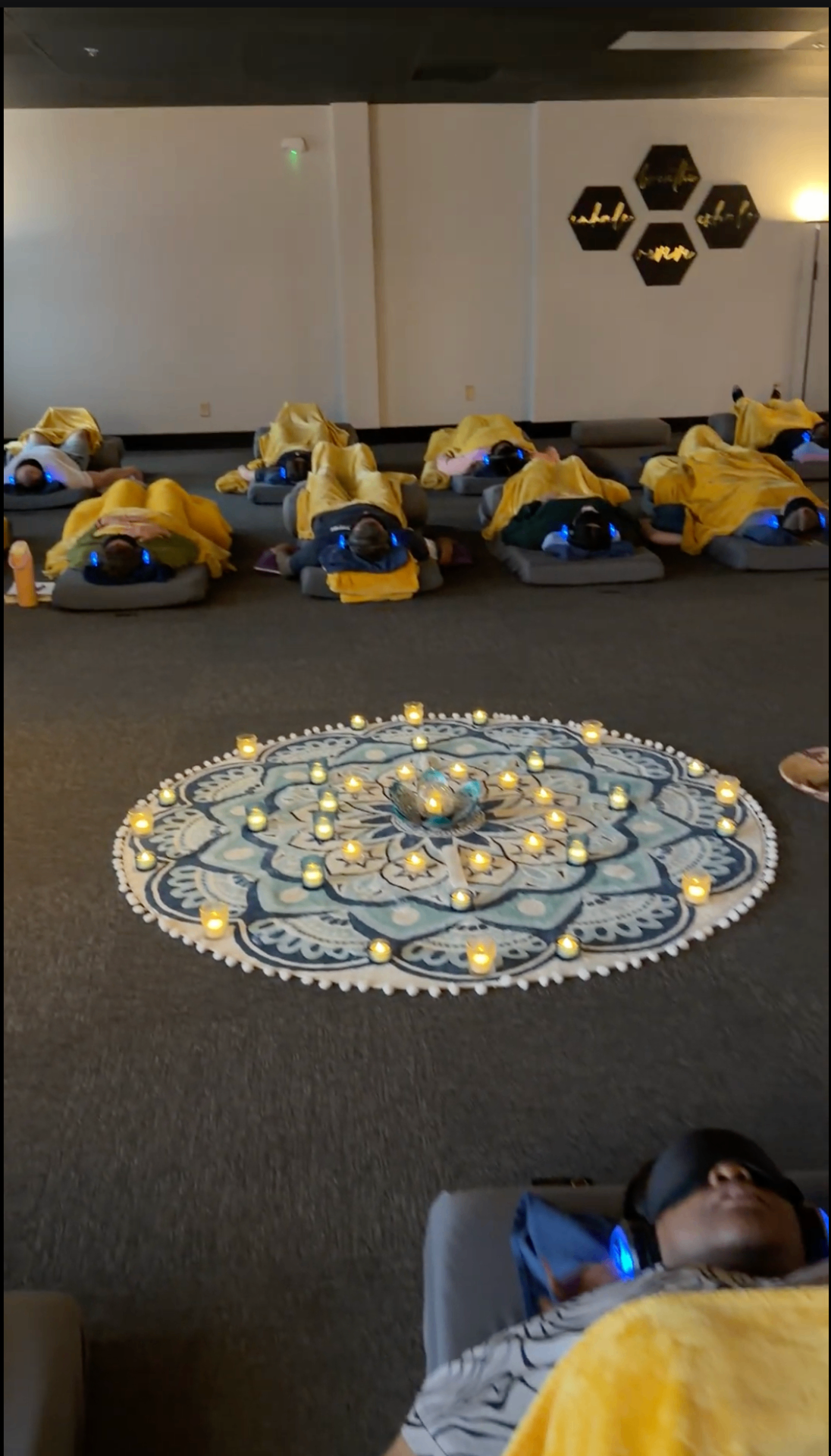 Candlelit mandala at the center of the studio